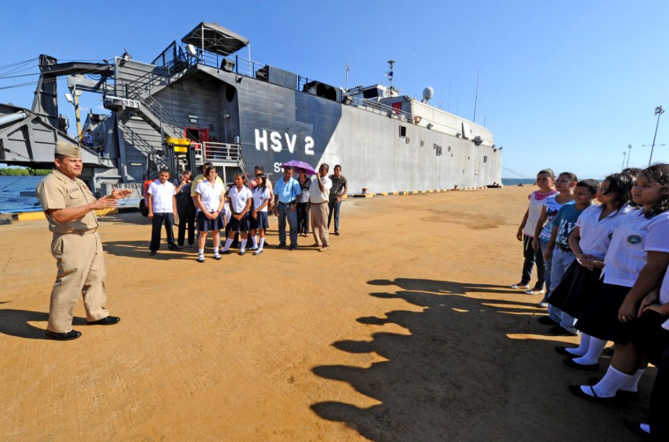US Navy 110303-N-WX845-025 Chief Hospital Corpsman Carls Enriquez, left, greets Basic Education Center Jose Cecilio del Valle students and faculty