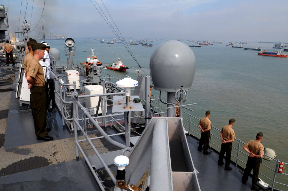 US Navy 110307-N-6692A-097 Sailors and Marines man the rails as USS Germantown (LSD 42) pulls away from the pier after a port visit in Indonesia
