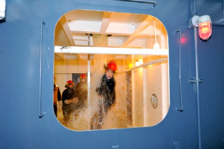 US Navy 110310-N-IK959-126 Midshipman 1st Class Angela Odom, from the University of Memphis Naval ROTC, attempts to egress from a flooding shipboar