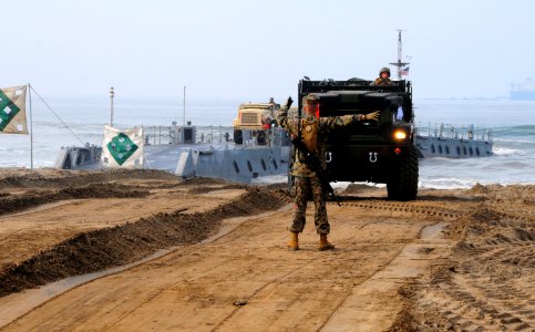 US Navy 110304-N-1786N-053 A Marine directs a medium tactical vehicle replacement vehicle during roll-on-roll-off discharge facility operations as