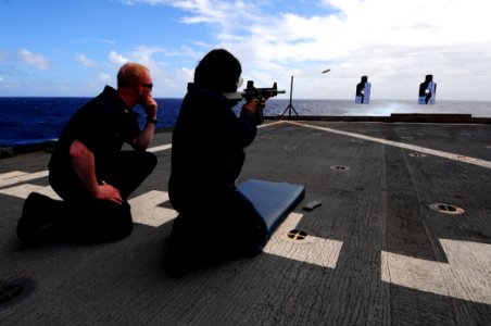 US Navy 110311-N-RC734-229 Fire Controlman 1st Class Daniel Boes, left, serves as a line coach while Boatswain's Mate 3rd Class Lakeisha Henderson