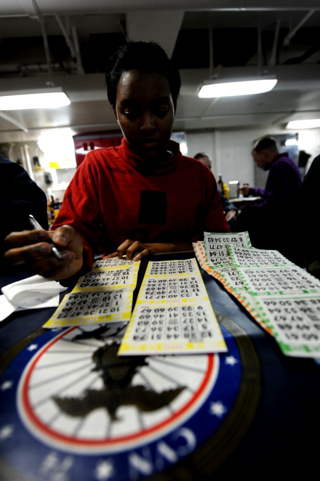 US Navy 110307-N-OY799-508 Aviation Ordnanceman Airman Jaessica Hughes, from Tuscaloosa, Ala., plays bingo on the mess decks during a ship-wide bin