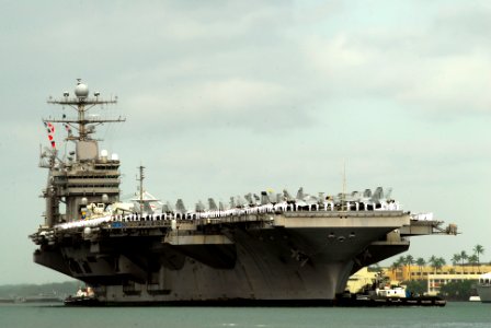 US Navy 110310-N-WP746-134 Sailors aboard the aircraft carrier USS Abraham Lincoln (CVN 72) man the rails as the ship passes the USS Arizona Memori