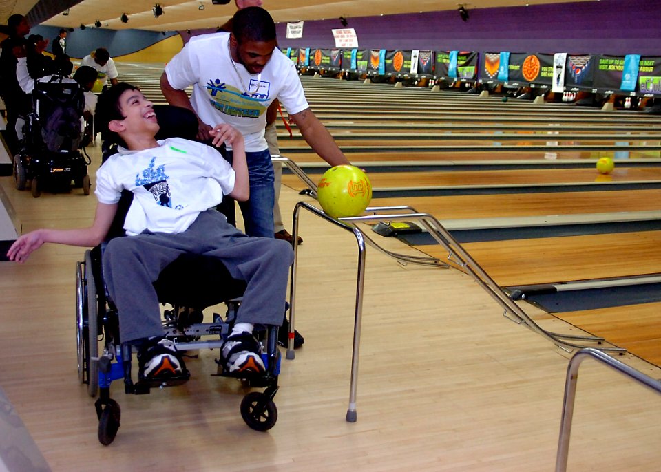 US Navy 110304-N-KV696-095 Master-at-Arms Seaman Quentin Benjamin, assigned to Naval Support Activity Washington, helps a Special Olympics bowler d