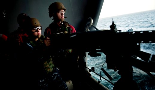 US Navy 110308-N-2055M-069 Master-at-Arms 3rd Class Kylie Zamora fires a .50-caliber machine gun during a gunnery exercise aboard the Nimitz-class