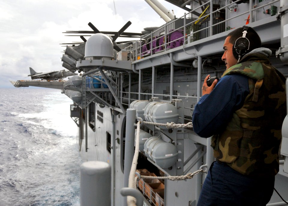 US Navy 110304-N-ZS026-004 Gunner's Mate 3rd Class Adam Torres, from Oxnard, Calif., communicates through a sound-powered phone while standing watc