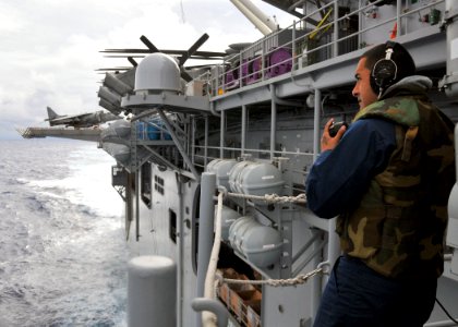 US Navy 110304-N-ZS026-004 Gunner's Mate 3rd Class Adam Torres, from Oxnard, Calif., communicates through a sound-powered phone while standing watc