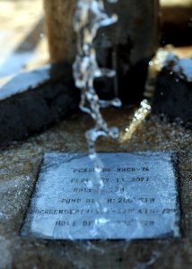 US Navy 110311-N-SN160-207 Water pours over the steel splash plate of a water well drilled by Seabees assigned to Naval Mobile Construction Battali