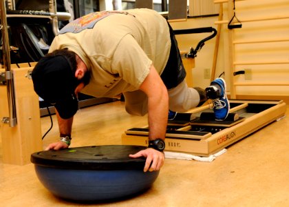 US Navy 110309-N-UB993-129 A Sailor mountain climbers using the core align pilates machine during a physical therapy appointment in the Comprehensi