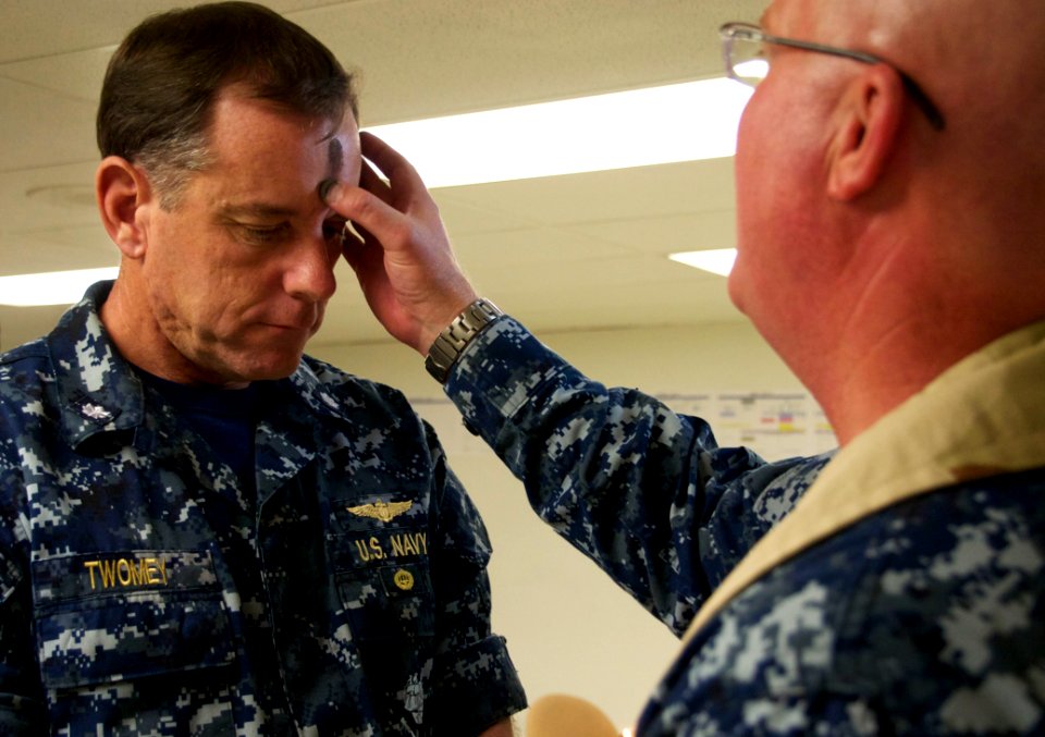 US Navy 110309-N-ZC343-375 Cdr. Kieran Twomey, Air Boss aboard the amphibious assault ship USS Bonhomme Richard (LHD 6), receives sacramental ashes