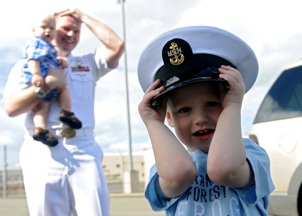 US Navy 110310-N-DX615-069 The son of Chief Information Systems Technician Jess Eisele wears his father's cover during a celebration for the arriva