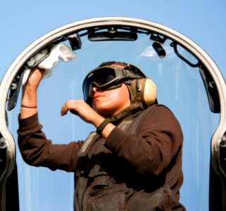 US Navy 110308-N-DR144-292 Aviation Structural Mechanic Airman Jodi Ramone, assigned to Strike Fighter Squadron (VFA) 25, cleans the canopy of an F