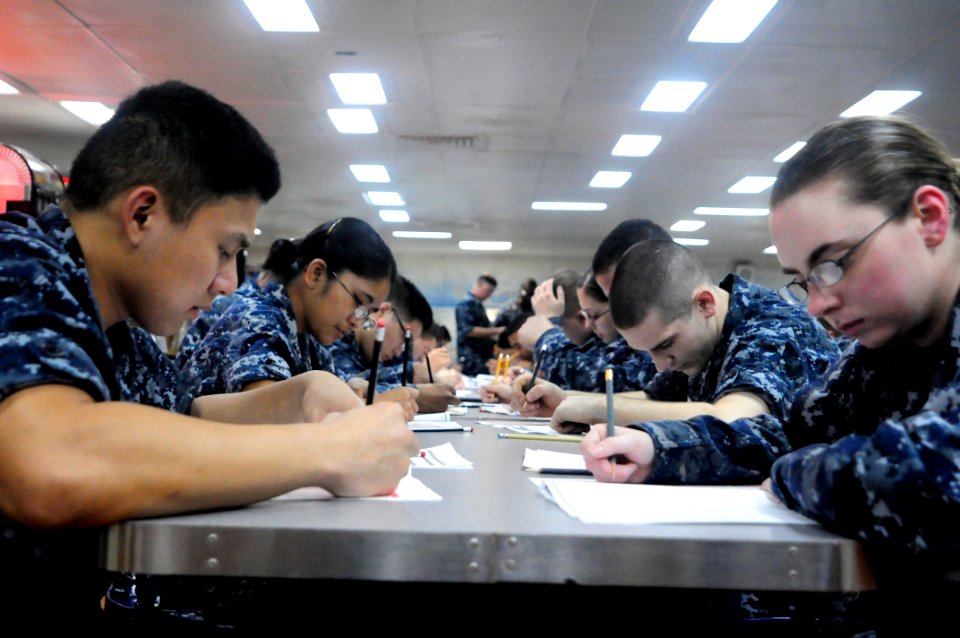 US Navy 110310-N-4920H-014 Sailors take the E-5 advancement exam on the mess decks aboard USS Essex (LHD 2)