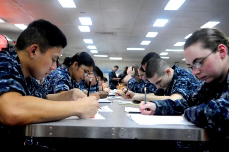 US Navy 110310-N-4920H-014 Sailors take the E-5 advancement exam on the mess decks aboard USS Essex (LHD 2)