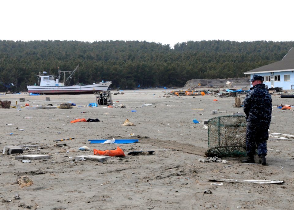 US Navy 110314-N-MU720-012 A Sailor assigned to Naval Air Facility Misawa (NAFM) hauls debris during a cleanup effort at the Misawa Fishing Port