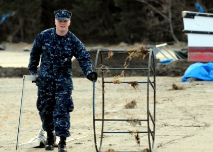 US Navy 110314-N-MU720-074 Information Systems Technician 2nd Class Lance Foster, from Garland, Texas, assigned to Naval Air Facility Misawa, remov