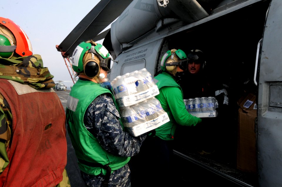 US Navy 110314-N-NB544-034 Sailors assigned to the Black Knights of Anti-Submarine Squadron (HS) 4 load supplies onto an HH-60H Sea Hawk helicopter