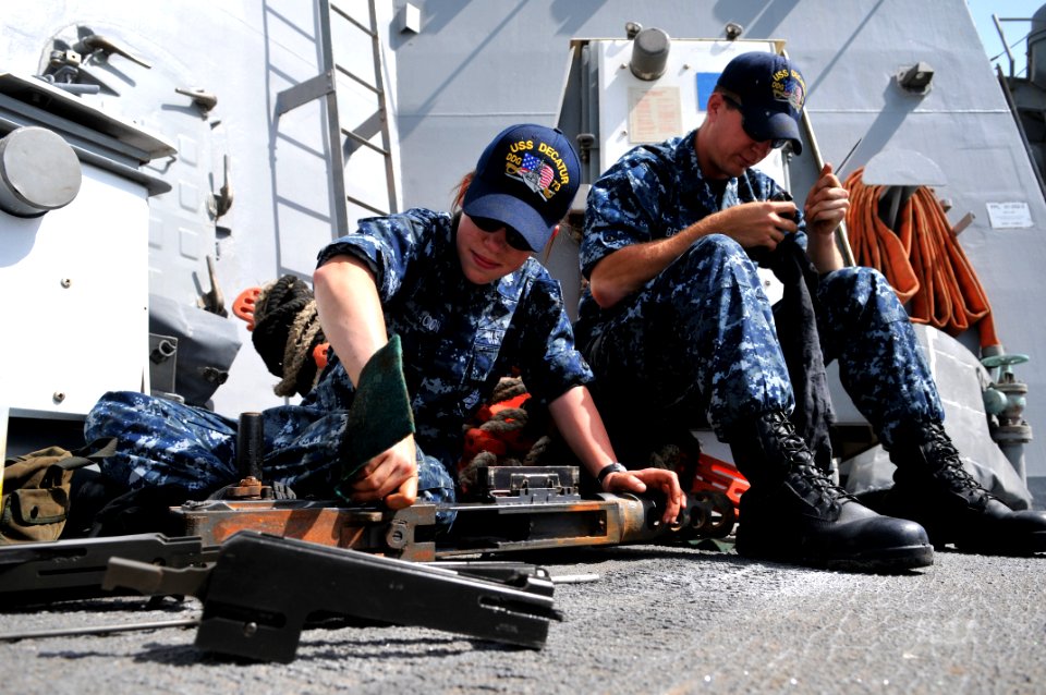 US Navy 110309-N-9818V-039 Gunner's Mate Seaman Recruit Erikka Macon conduct maintenance on the .50-caliber machine gun aboard USS Decatur (DDG 73)