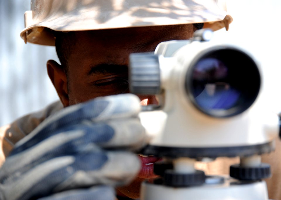 US Navy 110311-N-SN160-087 A Seabee uses an auto level to ensure an even foundation for a school under construction