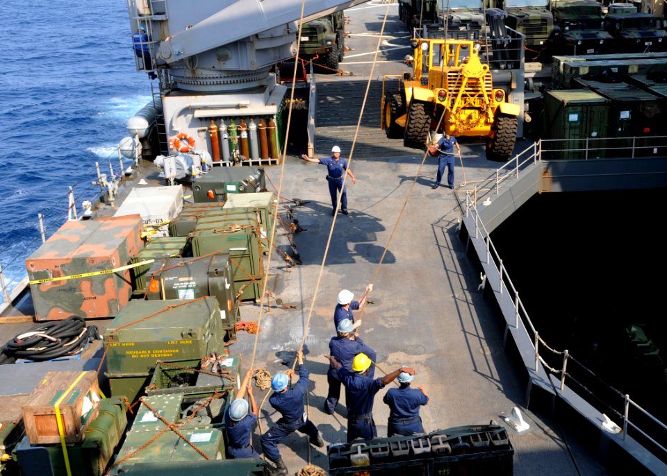 US Navy 110314-N-6692A-124 Sailors move a forklift aboard the amphibious dock landing ship USS Germantown (LSD 42)