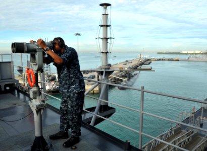 US Navy 110312-N-0864H-280 Operations Specialist 3rd Class Anthony Wilson looks through the
