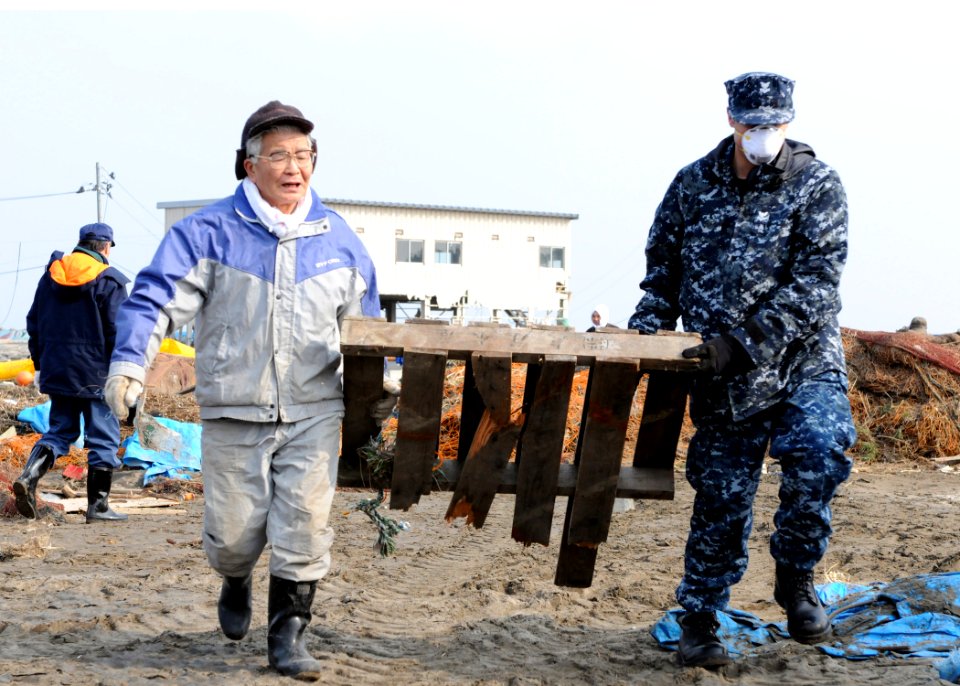 US Navy 110314-N-MU720-055 Aerographer's Mate 2nd Class John Dicola, from New York, assigned to Naval Air Facility Misawa, helps remove debris duri