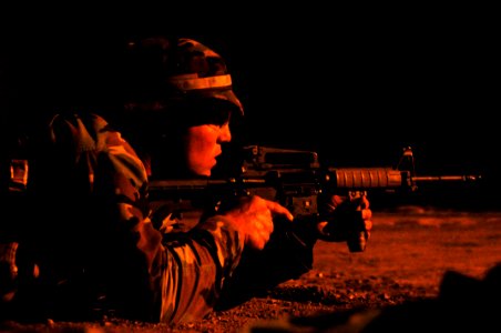 US Navy 110311-N-WB378-142 A student in the third and final phase of Basic Underwater Demolition-SEAL (BUD-S) training is illuminated by a flare wh