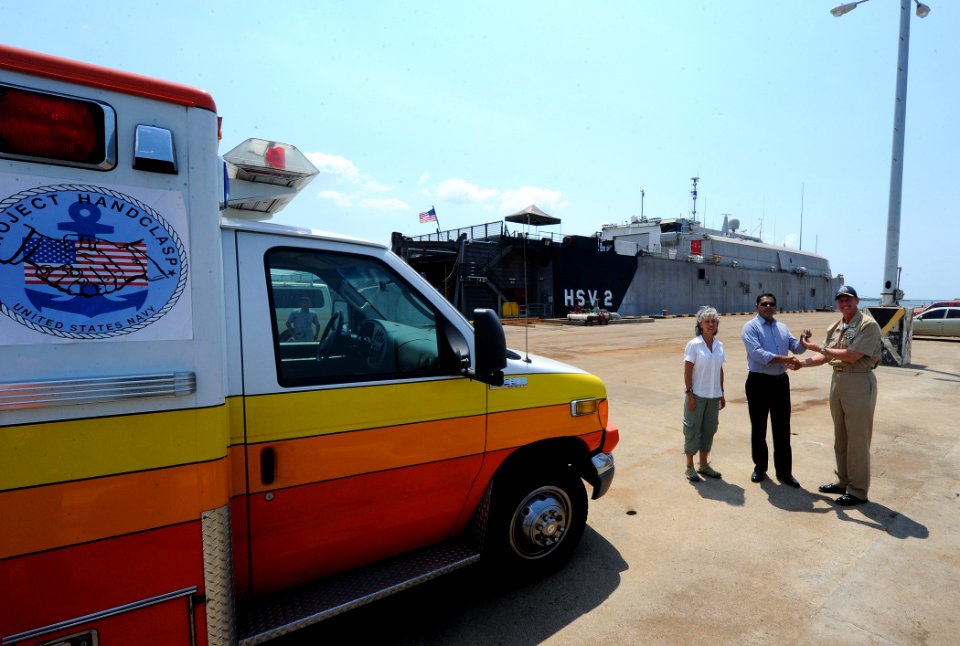 US Navy 110310-N-WX845-004 Cmdr. Mark Becker, right, mission commander of Southern Partnership Station 2011, passes the keys for an ambulance to Jo