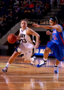 US Navy 110312-N-OA833-003 U.S. Naval Academy guard Angela Myers (^23) drives towards the basket during the Patriot League Tournament championship