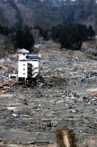 US Navy 110315-N-5503T-756 A Japanese search and rescue team searches the rubble near a high-rise building in Northern Japan
