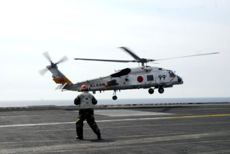 US Navy 110313-N-GL340-119 An SH-70B helicopter from the Japan Maritime Self-Defense Force lands aboard the aircraft carrier USS Ronald Reagan (CVN