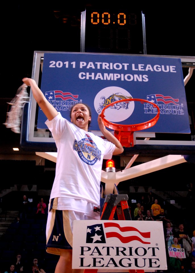 US Navy 110312-N-OA833-007 U.S. Naval Academy guard Angela Myers (^23) cuts down the net after the Midshipmen won the Patriot League Tournament ch