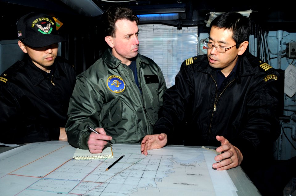 US Navy 110313-N-IC111-007 Capt. Jim Morgan, middle, commander of Destroyer Squadron 7, coordinates search and rescue efforts with Japan Maritime S