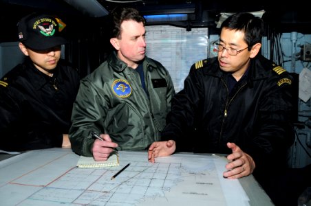 US Navy 110313-N-IC111-007 Capt. Jim Morgan, middle, commander of Destroyer Squadron 7, coordinates search and rescue efforts with Japan Maritime S