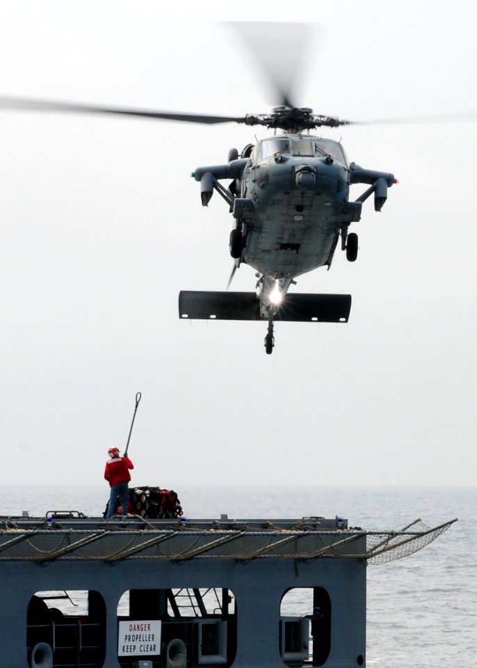 US Navy 110315-N-5538K-188 An MH-60S Sea Hawk helicopter transports humanitarian assistance supplies