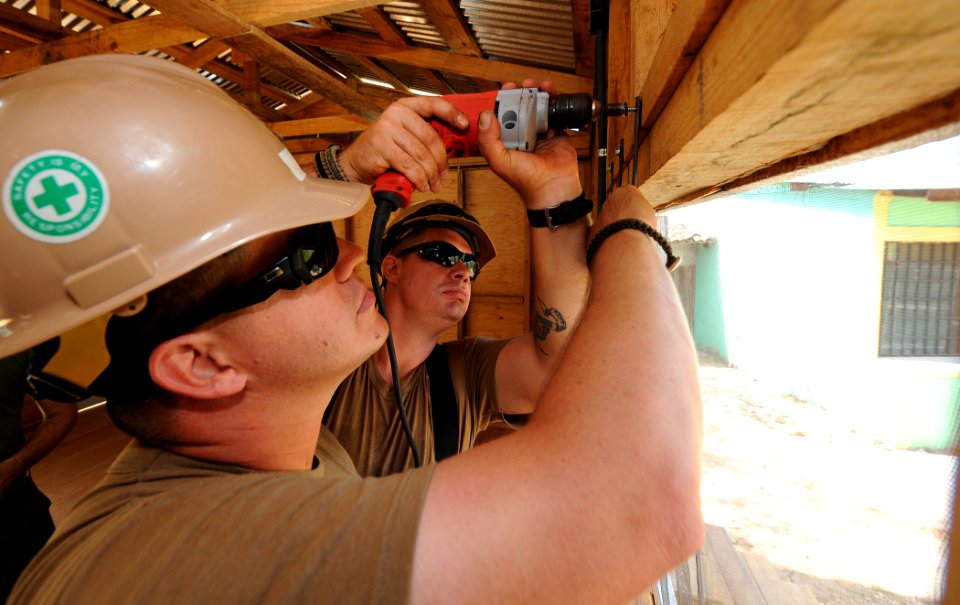 US Navy 110315-N-WX845-361 Builder 1st Class Clifton Horn and Builder 2nd Class Joshua Helton, assigned to Naval Mobile Construction Battalion (NMC