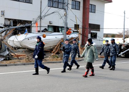 US Navy 110314-N-MU720-041 Masayoshi Sawaguchi, director of the Department of Policy and Finance for Misawa City, guides Sailors assigned to Naval