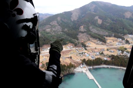 US Navy 110315-N-IC111-064 Chief Naval Air Crewman Steven Sinclair looks out from an HH-60H Sea Hawk helicopter assigned to the Black Knights of He