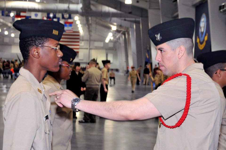 US Navy 110312-N-IK959-433 Boatswain's Mate 2nd Class Daniel Muniz, right, inspects a Navy Junior ROTC cadet