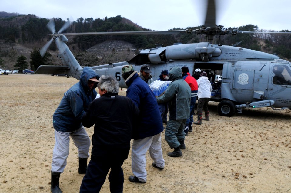 US Navy 110315-N-IC111-430 Japanese citizens receive supplies from Sailors assigned to the Black Knights of Helicopter Anti-Submarine Squadron (HS)