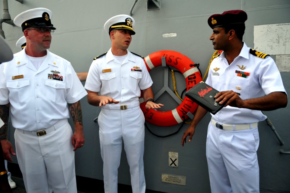 US Navy 110316-N-9818V-340 An Indian navy sailor, right, talks with Ensign Theodore Tom, center, and Chief Boatswain's Mate Timothy Vance during a
