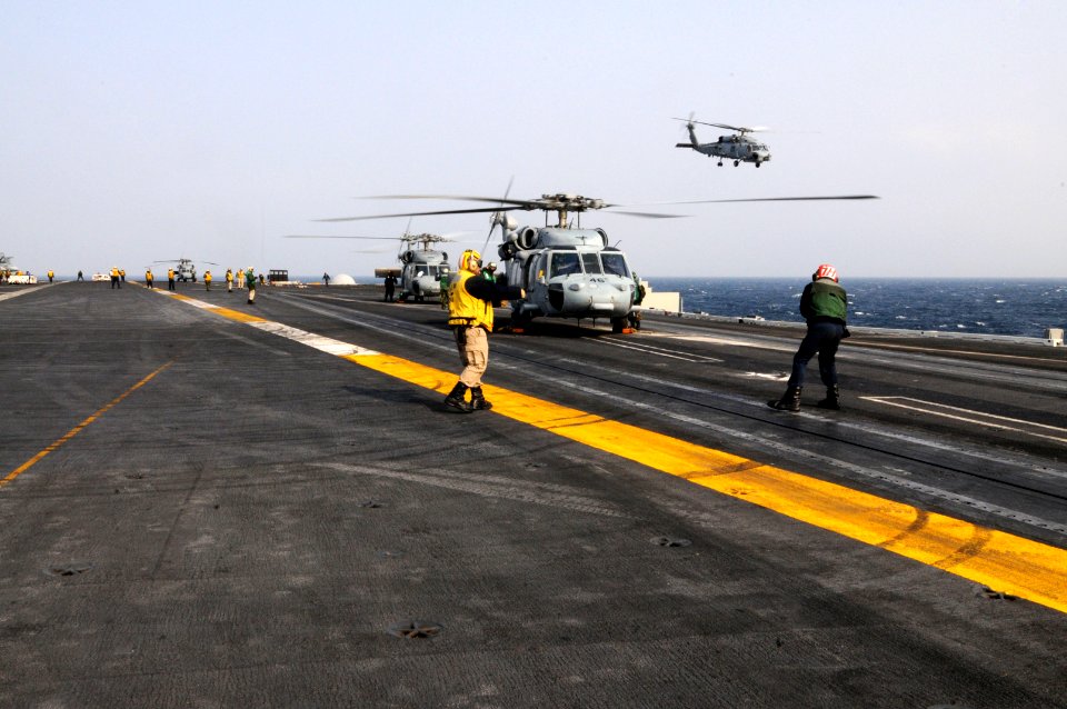 US Navy 110314-N-NB544-071 U.S. Navy Sea Hawk helicopters prepare to takes off from the aircraft carrier USS Ronald Reagan (CVN 76) to provide huma