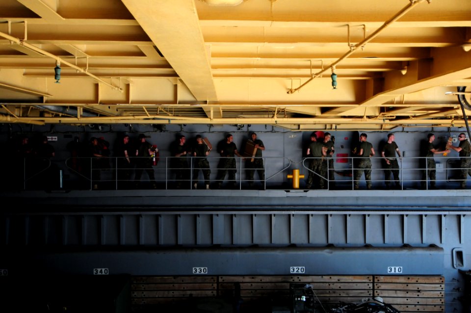 US Navy 110312-N-RC734-279 Marines participate in a working party on the starboard wing wall aboard the amphibious dock landing ship USS Comstock (