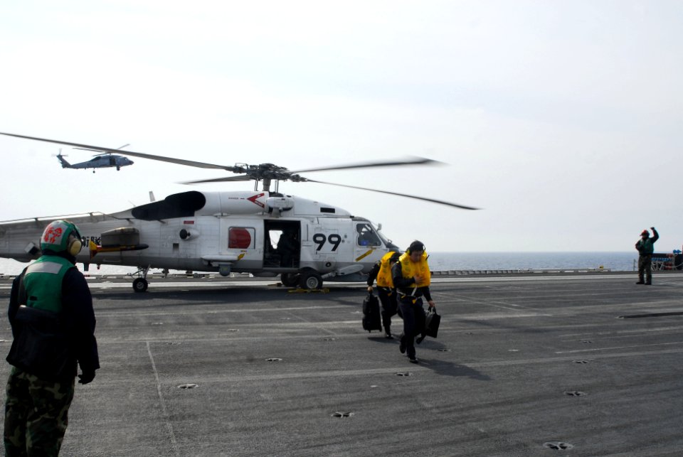 US Navy 110313-N-GL340-134 A Japan Maritime Self-Defense Force SH-70B helicopter lands on the flight deck of the aircraft carrier USS Ronald Reagan