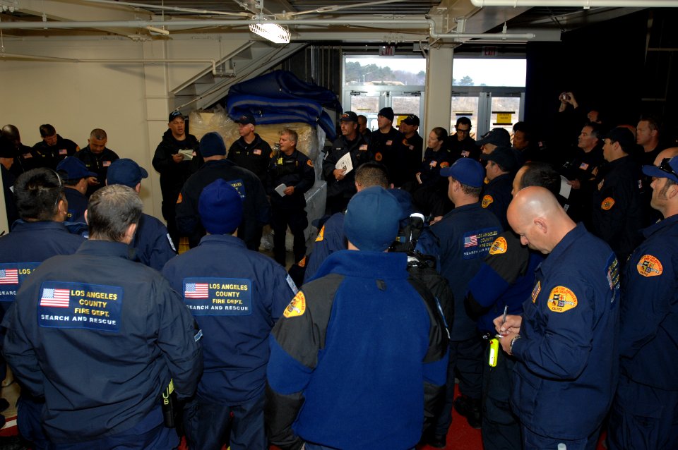 US Navy 110314-N-ZI955-068 Members of the Los Angeles County Fire Department Search and Rescue Team conduct a briefing before departing Naval Air F
