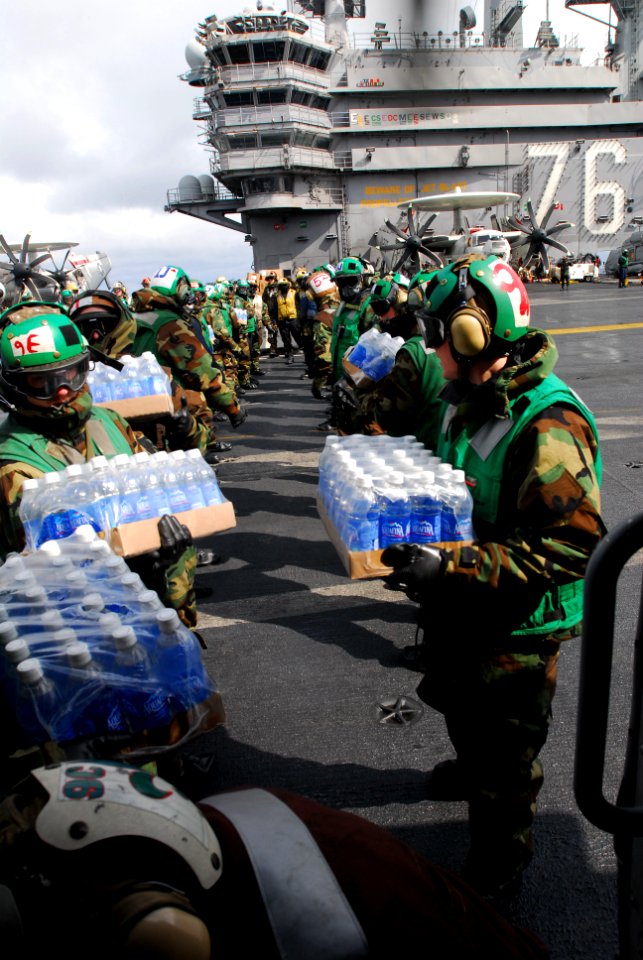 US Navy 110316-N-SB672-009 Sailors load bottled water on an HH-60H Sea Hawk helicopter assigned to the Black Knights of Helicopter Anti-Submarine S