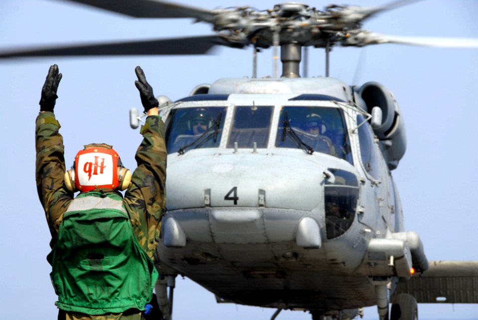 US Navy 110313-N-KF029-158 An SH-60F Sea Hawk helicopter assigned to the Black Knights of Helicopter Anti-Submarine Squadron (HS) 4, launches off t