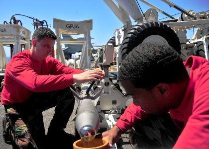 US Navy 110317-N-0074G-003 Aviation Ordnanceman Airman Luke Legaspi, left, and Aviation Ordnanceman Airman Michael Williams conduct a routine safet
