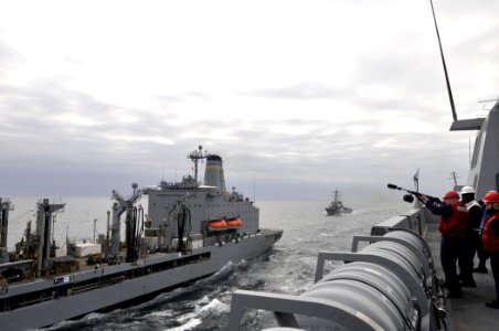 US Navy 110315-N-2147L-001 Gunner's Mate 2nd Class Taylor Perkins prepares to fire a shot line from the amphibious transport dock ship USS New York