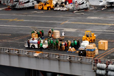 US Navy 110316-N-SB672-301 Sailors prepare supplies to be loaded onto helicopters aboard the aircraft carrier USS Ronald Reagan (CVN 76)